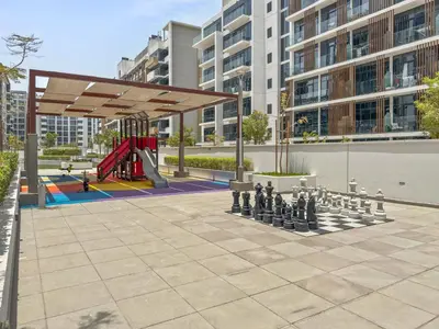 a playground with a giant chessboard in a park at Elite Escape - Boho Getaway in Azizi Riviera 16 in Dubai