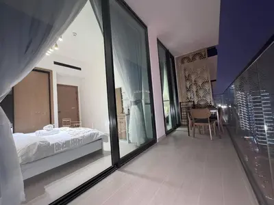 a bedroom with a bed and a large glass window at 2 Bed, Private Pool, Big Terrace, Solysian Stay in Dubai