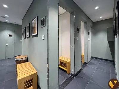 a hallway with a row of lockers and a bench at Vogue Business Bay Damac Cour Jardin close to Downtown, Burj Khalifa and Dubai Mall, Studio Apartment with City View, Access to all Amenities in Dubai
