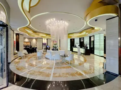a lobby with a chandelier and a table and chairs at Vogue Business Bay Damac Cour Jardin close to Downtown, Burj Khalifa and Dubai Mall, Studio Apartment with City View, Access to all Amenities in Dubai