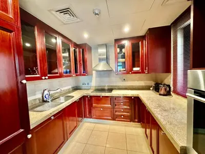 a kitchen with wooden cabinets and a sink at Only family Walking distance to Dubai Mall in Dubai