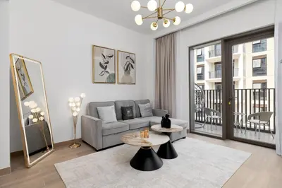 a living room with a couch and a table at Maison Privee - Charming Urban Escape with Resort-Style Facilities in Dubai