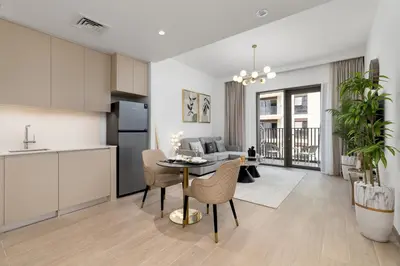 a kitchen and living room with a table and chairs at Maison Privee - Charming Urban Escape with Resort-Style Facilities in Dubai