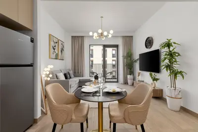 a living room with a table and chairs in a room at Maison Privee - Charming Urban Escape with Resort-Style Facilities in Dubai