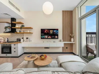 a living room with a couch and a table at Stylish 1BR in Socio Pool, Cinema & Game Lounge in Dubai