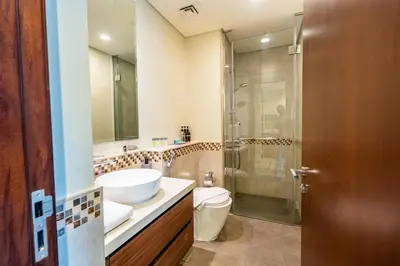 a bathroom with a sink and a toilet and a shower at Modern 1BR in Business Bay Balcony Pool Access in Dubai
