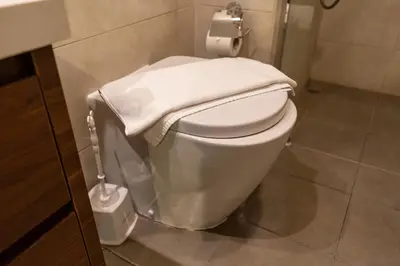 a bathroom with a toilet with a towel on it at Modern 1BR in Business Bay Balcony Pool Access in Dubai