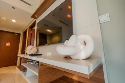 a bathroom with a white swan sculpture on a counter at Modern 1BR in Business Bay Balcony Pool Access in Dubai