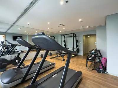 a gym with several exercise bikes in a room at GuestReady – Relax Stay w Balcony & Pool View in Dubai