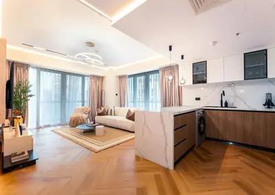 an open kitchen and living room with a couch at Modern 2-BR in 8-BLVD WALK Downtown Dubai in Dubai
