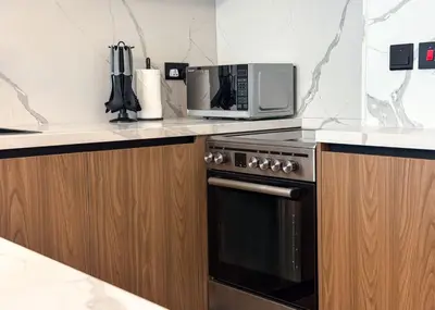 a kitchen with a microwave and a stove at Modern 2-BR in 8-BLVD WALK Downtown Dubai in Dubai