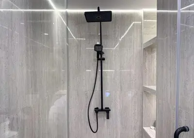 a shower with a shower head in a shower at Modern 2-BR in 8-BLVD WALK Downtown Dubai in Dubai