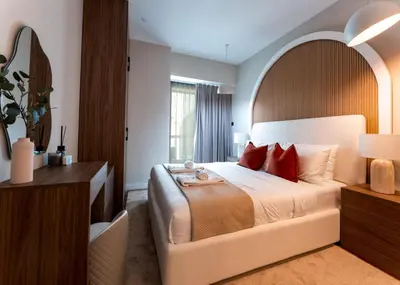 a bedroom with a large bed with red pillows at Modern 2-BR in 8-BLVD WALK Downtown Dubai in Dubai