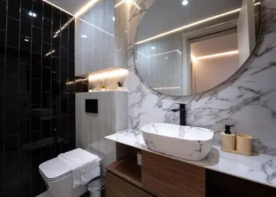 a bathroom with a sink and a mirror and a toilet at Modern 2-BR in 8-BLVD WALK Downtown Dubai in Dubai