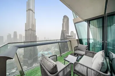 a balcony with chairs and a view of a city at FIRST CLASS 3BR Stunning Burj Khalifa View in Dubai