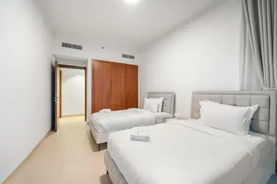 a hotel room with two beds and a doorway at FIRST CLASS 3BR Stunning Burj Khalifa View in Dubai