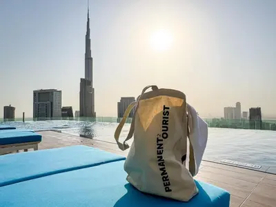 a bag sitting on a table with a view of a city at 64th Floor Infinity Pool 2BR Best Burj Khalifa View in Dubai