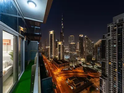a view of a city at night from a building at 64th Floor Infinity Pool 2BR Best Burj Khalifa View in Dubai