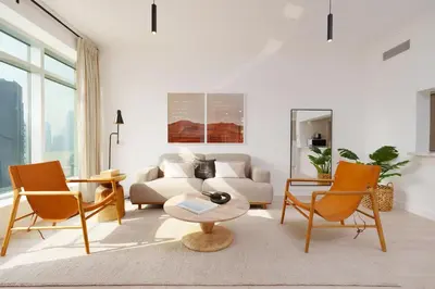 a living room with a couch and chairs and a table at Burj Views East, Downtown - Mint Stay in Dubai