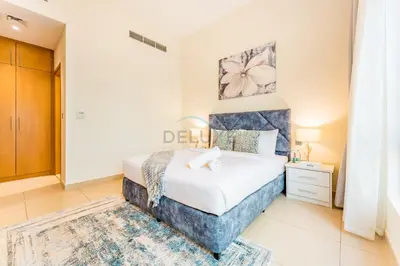 a bedroom with a king sized bed in a room at Spacious 4BR Plus Maids Villa, Near Avenue Mall, Cycle Park & Sports Complex - 15 Mins to Downtown Dubai, Nad Al Shiba Third by Deluxe Holiday Homes in Dubai