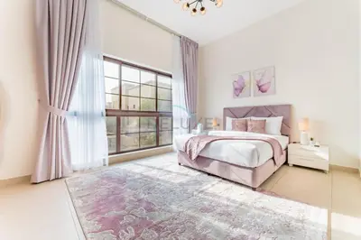 a bedroom with a bed and a large window at Spacious 4BR Plus Maids Villa, Near Avenue Mall, Cycle Park & Sports Complex - 15 Mins to Downtown Dubai, Nad Al Shiba Third by Deluxe Holiday Homes in Dubai