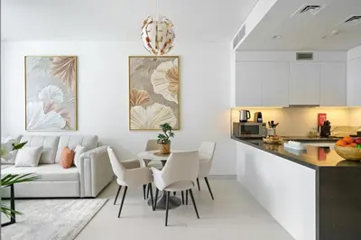 a kitchen and living room with a couch and a table at DAYF-JFH Spacious Apartment 4 PAX with Magical Lagoon Views in Dubai