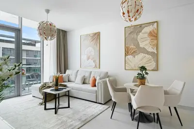 a living room with a couch and a table and chairs at DAYF-JFH Spacious Apartment 4 PAX with Magical Lagoon Views in Dubai