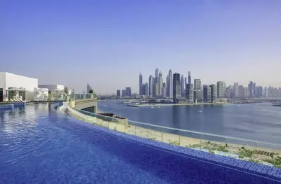 a large body of water with a city in the background at FIRST CLASS Studio Infinity Pool and Luxe Vibes in Dubai