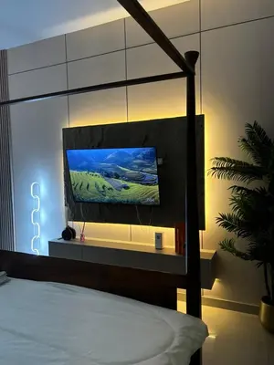 a bedroom with a bed with a tv on a wall at Al Zarooni building, Dubai marina in Dubai