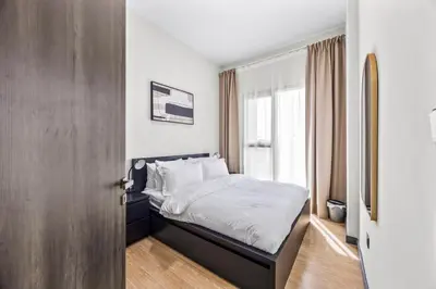 a bedroom with a bed and a window at Cosy Apartment in Dubailand near Global Village in Dubai
