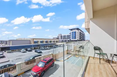 a balcony with a view of a parking lot at Cosy Apartment in Dubailand near Global Village in Dubai