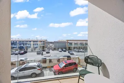 a balcony with a view of a parking lot at Cosy Apartment in Dubailand near Global Village in Dubai