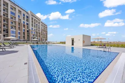 an image of a swimming pool at a hotel at Cosy Apartment in Dubailand near Global Village in Dubai