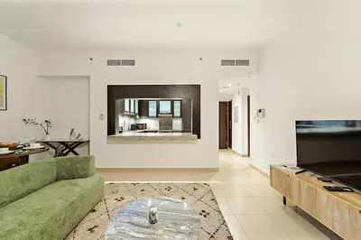 a living room with a couch and a table at FIRST CLASS 1BR Modern Urban Retreat in Dubai