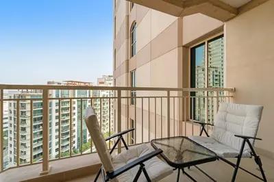 a balcony with two chairs and a table at FIRST CLASS 1BR Modern Urban Retreat in Dubai