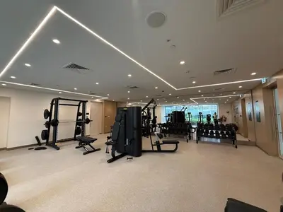a gym with treadmills and equipment in a building at Island Park Comfort Stay in Dubai