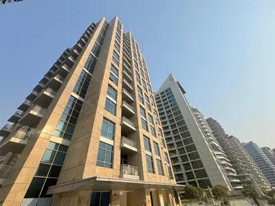 a tall building with two tall buildings at Luxury 1BR with Pool, Gym Canal & Burj Khalifa view in Dubai