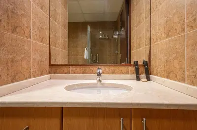a bathroom with a sink and a mirror at Luxury 1BR with Pool, Gym Canal & Burj Khalifa view in Dubai