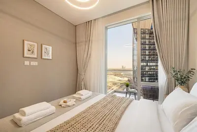 a bedroom with a bed and a large window at Vida Dubai Mall! Excellent Amenities! Direct Access To Dubai Mall in Dubai