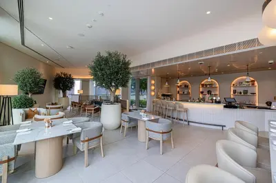 a restaurant with tables and chairs and a bar at Vida Dubai Mall! Excellent Amenities! Direct Access To Dubai Mall in Dubai
