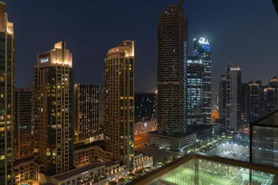 a city skyline at night with tall buildings at Modern 1BR - Fitness & Swimming Pool Access in Dubai