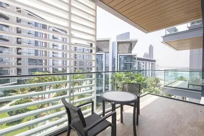 a balcony with a table and chairs on a building at Spacious Luxury 1BR Modern Design Bluewaters in Dubai