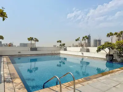 a large swimming pool on top of a building at Silkhaus Classic 1BDR Stay in Jumeirah Village in Dubai