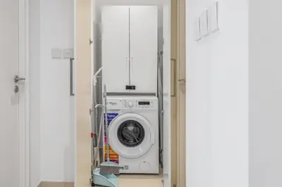 a washer and dryer in a hospital room at Modern 1BR apartment in Burj Crown in Dubai