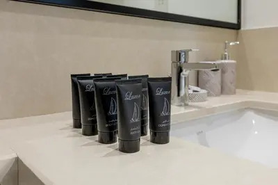 a row of black toothbrushes sitting on a bathroom counter at Modern 1BR apartment in Burj Crown in Dubai