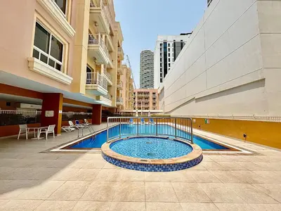a swimming pool in the middle of a building at Homes2Retreat - JVC Charm - 1BR Apt with Private Balcony in Dubai