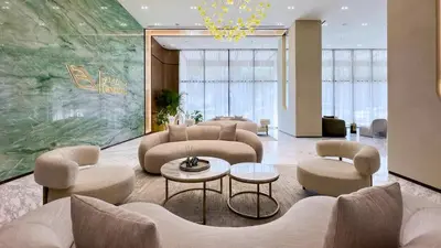 a lobby with couches and chairs and a chandelier at TRPS - Binghatti Onyx JVC - Luxury 2BR with Private Pool in Dubai