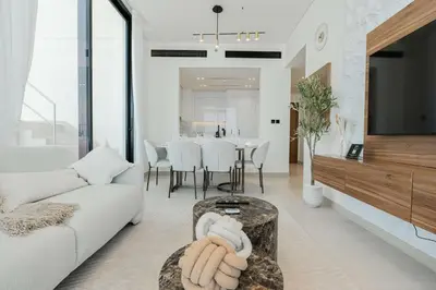 a living room with a white couch and a table at TRPS - Binghatti Onyx JVC - Luxury 2BR with Private Pool in Dubai