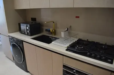 a kitchen with a stove top and a microwave at Binghatti Dusk Studio with Gym &Pool in Dubai