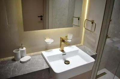 a bathroom with a white sink and a mirror at Binghatti Dusk Studio with Gym &Pool in Dubai